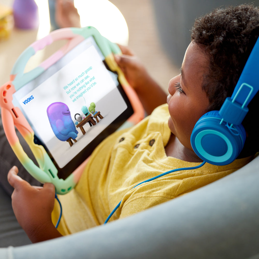 A child enjoying an animated story on a tablet