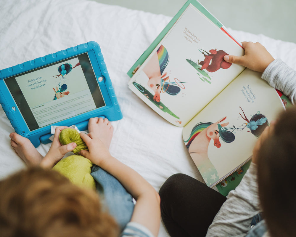 Children sharing storytime with books and a tablet